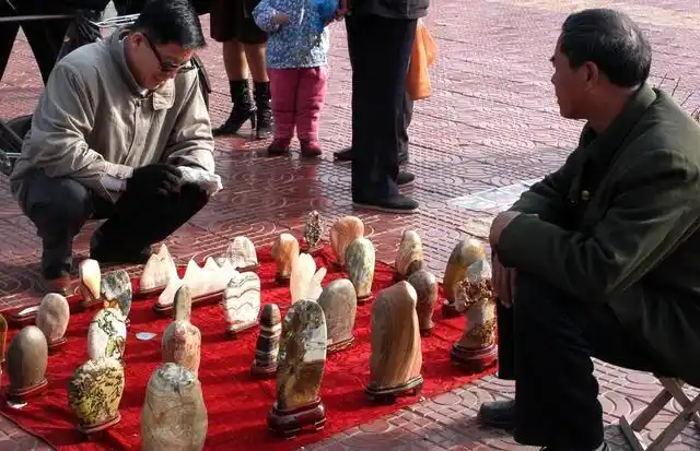 尽管卖奇石的摊位摆的很长,但光顾购买的并不过,他们对于奇石还缺失