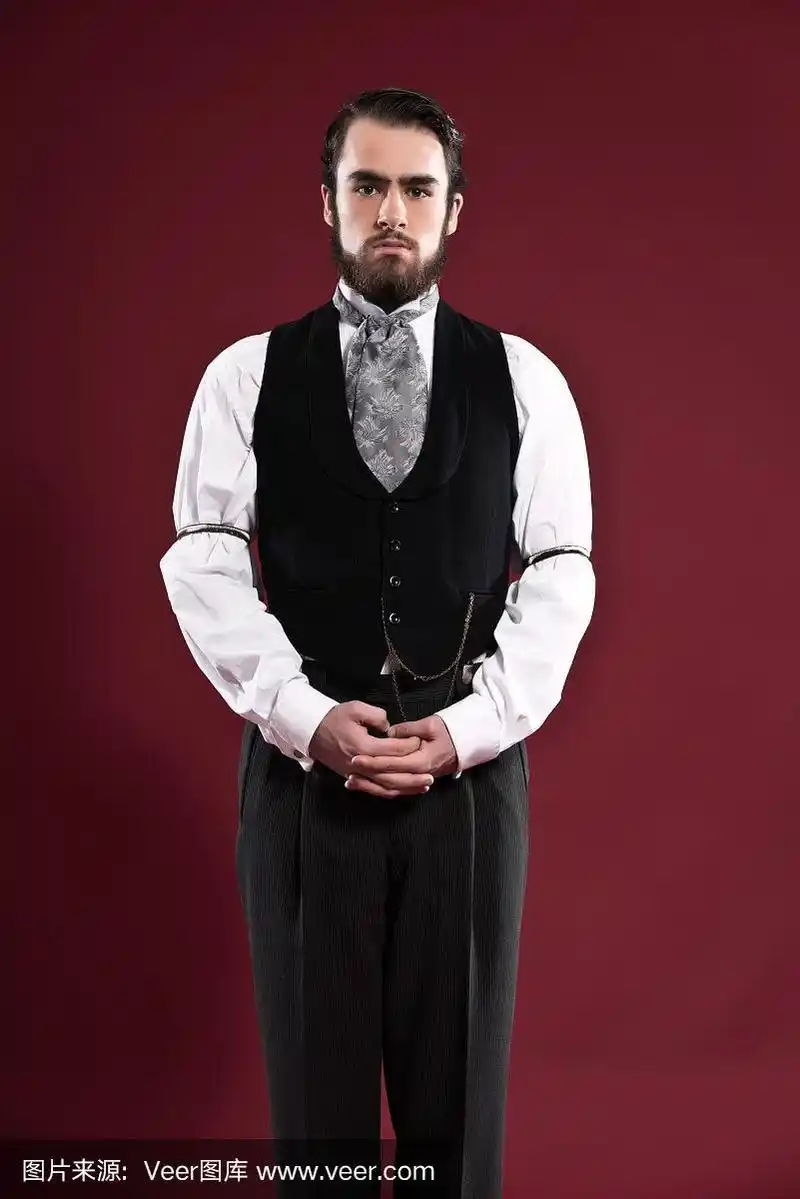 复古1900年维多利亚时代的时尚男子,留着胡子,穿着黑色马甲.