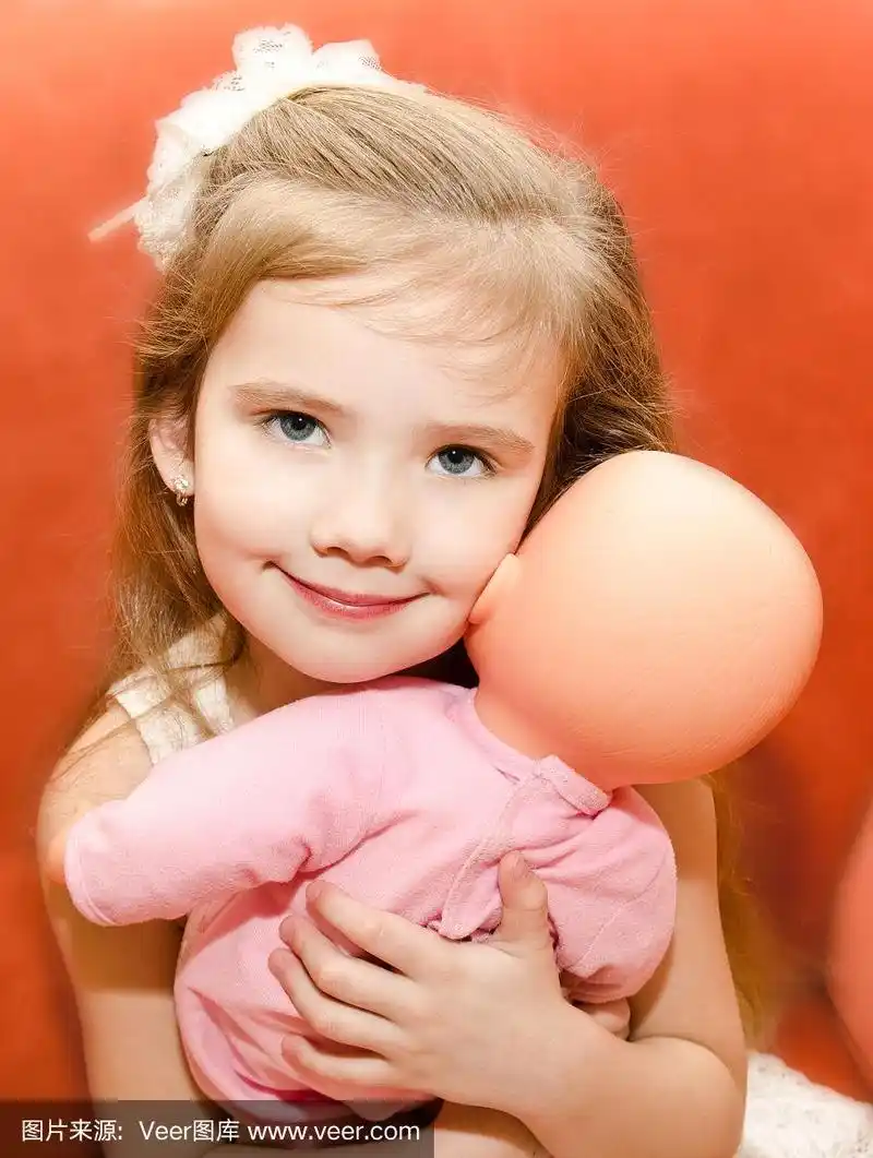 可爱的小女孩在玩洋娃娃