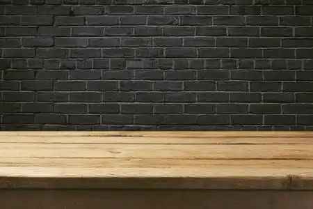 复古表和黑色砖墙照片