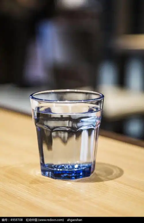 in my room. there is   cup of water on the  table.