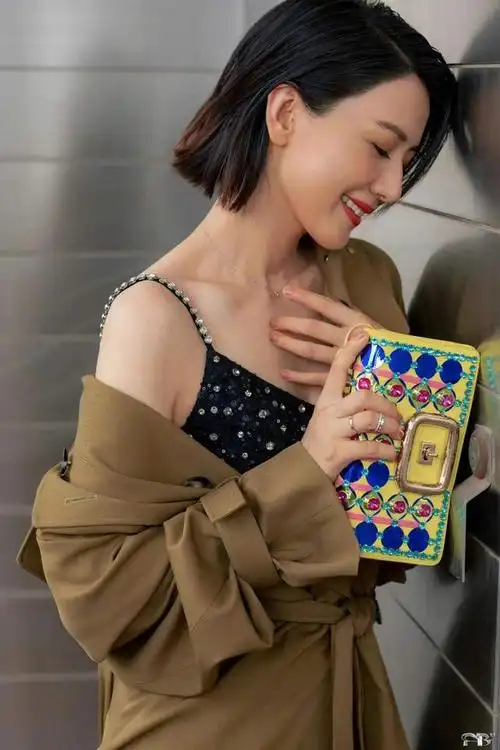 高圆圆魅力依旧风衣内搭亮片裙柔美浪漫偏分短发利落洒脱