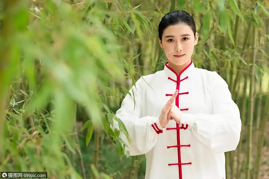站在竹叶下的女性双手抱拳模特太极