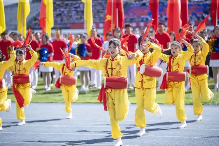 迎来阵阵掌声双色旗帜和扇子的交替变化,呈现出的艺术字表达了师生们